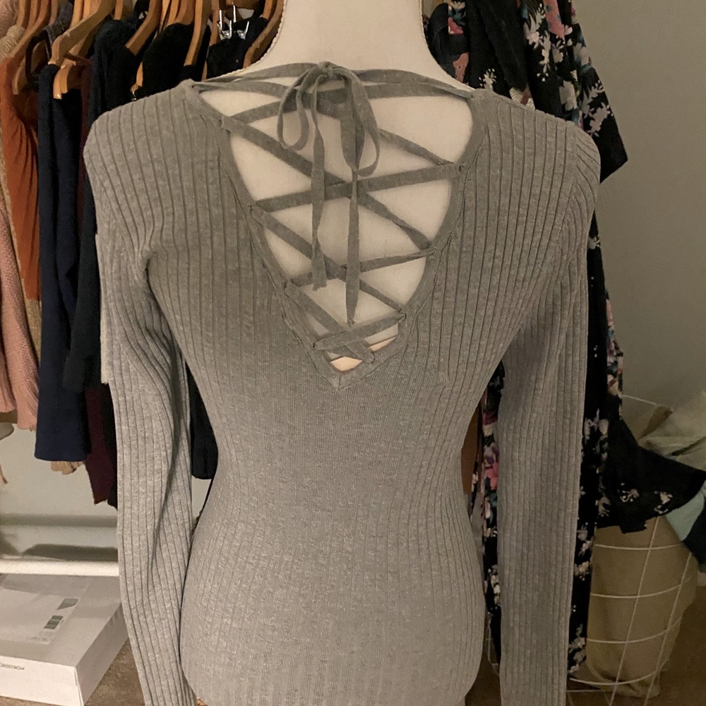 Ribbed V neck top with laced v in back. New never worn with boutique tag.